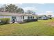 Lush backyard with patio seating, providing a perfect spot for outdoor relaxation and social gatherings at 1015 Harefield Cir, Sun City Center, FL 33573