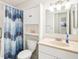 Bathroom featuring white cabinets, a shower with a blue curtain, and a single sink at 1015 Harefield Cir, Sun City Center, FL 33573