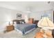Bedroom with light walls, carpet flooring, a ceiling fan, and a wooden furniture set at 1015 Harefield Cir, Sun City Center, FL 33573