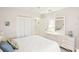 Bedroom with a double closet, access to the bathroom, and neutral colored walls at 1015 Harefield Cir, Sun City Center, FL 33573
