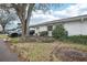 Charming home with mature landscaping, complemented by an attached carport at 1015 Harefield Cir, Sun City Center, FL 33573