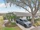 Attractive single-story home featuring a lush front yard with mature palms and ample driveway parking at 1015 Harefield Cir, Sun City Center, FL 33573
