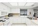 Bright and classic white kitchen with modern appliances and a tiled backsplash at 1015 Harefield Cir, Sun City Center, FL 33573