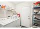 Laundry room featuring a washer and dryer and storage shelves at 1015 Harefield Cir, Sun City Center, FL 33573