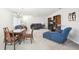 Comfortable living room featuring carpet flooring and a combined dining area at 1015 Harefield Cir, Sun City Center, FL 33573