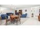 Spacious living room featuring comfortable seating, carpet flooring, and natural light at 1015 Harefield Cir, Sun City Center, FL 33573