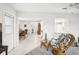 Bright and airy living room open to kitchen and dining areas, filled with comfortable, tropical furniture at 1015 Harefield Cir, Sun City Center, FL 33573