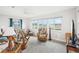 Cozy living room with a view of the outdoors, bright lighting, and comfortable, tropical furniture at 1015 Harefield Cir, Sun City Center, FL 33573