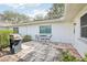 Cozy patio with tiled flooring, outdoor seating, and a grill, creating an inviting space for relaxation at 1015 Harefield Cir, Sun City Center, FL 33573