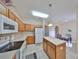 Well-lit kitchen features an island, tile flooring, and essential appliances at 10730 Shady Preserve Dr, Riverview, FL 33579