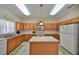 Spacious kitchen with an island, tile floors, and ample counter space for cooking at 10730 Shady Preserve Dr, Riverview, FL 33579