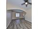 Spacious living room with stylish wood flooring, ceiling fan, and plenty of natural light at 10730 Shady Preserve Dr, Riverview, FL 33579