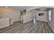 Spacious living room with stylish wood flooring, staircase, and plenty of natural light at 10730 Shady Preserve Dr, Riverview, FL 33579