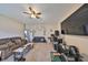 Spacious living room with neutral carpet, ceiling fan, and ample space for furniture at 10730 Shady Preserve Dr, Riverview, FL 33579