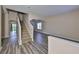 Spacious living room with stylish wood flooring, staircase, and plenty of natural light at 10730 Shady Preserve Dr, Riverview, FL 33579