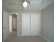 Bedroom features include neutral walls, carpeted floor, and a closet with bi-fold doors at 10811 Brickside Ct, Riverview, FL 33579