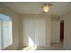 Bedroom with carpeted floor, a ceiling fan, and white horizontal blinds on the window at 10811 Brickside Ct, Riverview, FL 33579