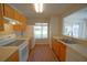 Well-lit kitchen features essential appliances and wooden cabinets for plenty of storage and functionality at 10811 Brickside Ct, Riverview, FL 33579