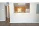 The kitchen has wooden cabinets, a serving hatch and white appliances at 10811 Brickside Ct, Riverview, FL 33579