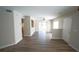 Open concept living room with sliding glass doors offering ample natural light and hardwood floors at 10811 Brickside Ct, Riverview, FL 33579