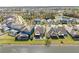 An aerial view highlights homes backing onto a pond, complete with screened-in pools and fenced yards at 11421 Quiet Forest Dr, Tampa, FL 33635