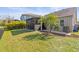Expansive backyard with lush lawn and screened lanai, great for outdoor enjoyment at 11421 Quiet Forest Dr, Tampa, FL 33635