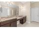 Spacious bathroom features double vanity with granite countertops and stylish fixtures at 11421 Quiet Forest Dr, Tampa, FL 33635