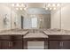 Bathroom featuring double vanity with granite countertops, decorative mirror, and recessed lighting at 11421 Quiet Forest Dr, Tampa, FL 33635