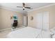 Bright bedroom features a ceiling fan, work station, a walk in closet and neutral decor at 11421 Quiet Forest Dr, Tampa, FL 33635