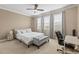 Bright bedroom with natural light, neutral colors, and a comfortable workspace at 11421 Quiet Forest Dr, Tampa, FL 33635