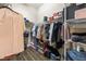 Walk-in closet with wire shelving, plenty of storage space, and wood-look floors at 11421 Quiet Forest Dr, Tampa, FL 33635