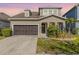 Charming two-story home featuring a well-manicured lawn and an attached two-car garage at 11421 Quiet Forest Dr, Tampa, FL 33635