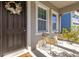 Inviting front porch area with modern seating, a decorative wreath, and a welcoming entrance at 11421 Quiet Forest Dr, Tampa, FL 33635
