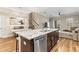 Open-concept kitchen with a large island, stainless steel appliances, and hardwood floors at 11421 Quiet Forest Dr, Tampa, FL 33635