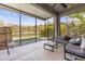 Screened-in lanai with comfortable seating provides relaxing views of the pond at 11421 Quiet Forest Dr, Tampa, FL 33635