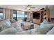 Bright living room featuring ocean views, a large entertainment center, and plush seating at 1340 Gulf Blvd # 6E, Clearwater Beach, FL 33767