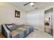 Bright bedroom featuring a ceiling fan and a double door closet with a view into the hallway at 14129 Prospect St, Spring Hill, FL 34609