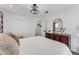 Bedroom featuring ceiling light, a dresser with a mirror and carpet at 14247 Spanish Wells Dr, Hudson, FL 34667