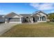 Charming single-story home with a well-manicured lawn, neutral color palette, and inviting entrance at 14247 Spanish Wells Dr, Hudson, FL 34667