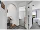 Hallway showcasing an arched doorway, updated flooring, and a view into the bedrooms at 14247 Spanish Wells Dr, Hudson, FL 34667