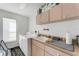Functional laundry room with ample cabinet space, a utility sink, and a washer and dryer at 14247 Spanish Wells Dr, Hudson, FL 34667