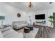 Inviting living room with comfortable seating, a large TV, and stylish decor at 14247 Spanish Wells Dr, Hudson, FL 34667