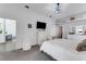 Bright main bedroom featuring a large bed, dresser, neutral colors, and an open layout at 14247 Spanish Wells Dr, Hudson, FL 34667