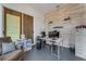 Bright office space featuring a desk, chair, slider doors, and a decorative accent wall at 14247 Spanish Wells Dr, Hudson, FL 34667