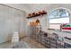 Organized walk-in closet with shelves, storage boxes, hanging space, and a view from a window at 14247 Spanish Wells Dr, Hudson, FL 34667