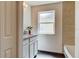 Bright bathroom featuring a tiled shower wall, modern vanity, and a frosted glass window at 14330 Channel Dr, Largo, FL 33774