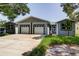 The house has a 2-car garage and is painted in a light color at 14330 Channel Dr, Largo, FL 33774