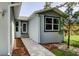 Charming front exterior features a newly painted finish, a walkway and a well-manicured lawn at 14330 Channel Dr, Largo, FL 33774