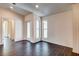 Neutral living room with wood look floors and three windows at 14330 Channel Dr, Largo, FL 33774