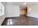 Living room with wood-look floors and access to dining room and kitchen at 14330 Channel Dr, Largo, FL 33774